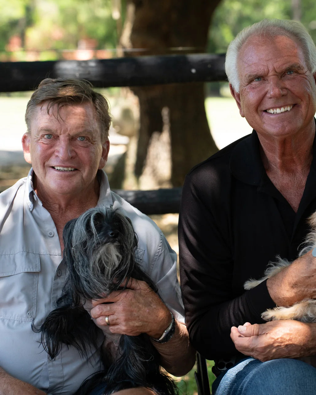 Danny Robertshaw and Ron Danta of Danny & Ron's Rescue, each holding a rescue dog